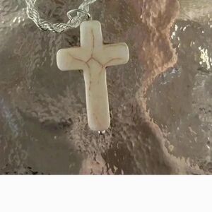Cross On A Silver Stainless Steel Necklace.